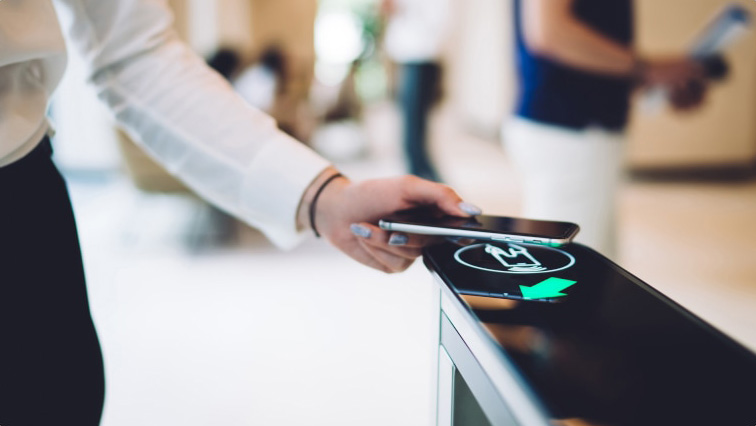 person scanning their smartphone at checkout