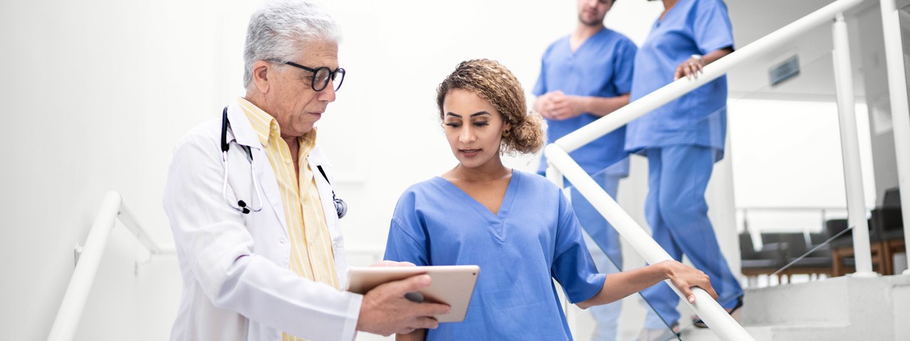 emergency room workers looking at a tablet
