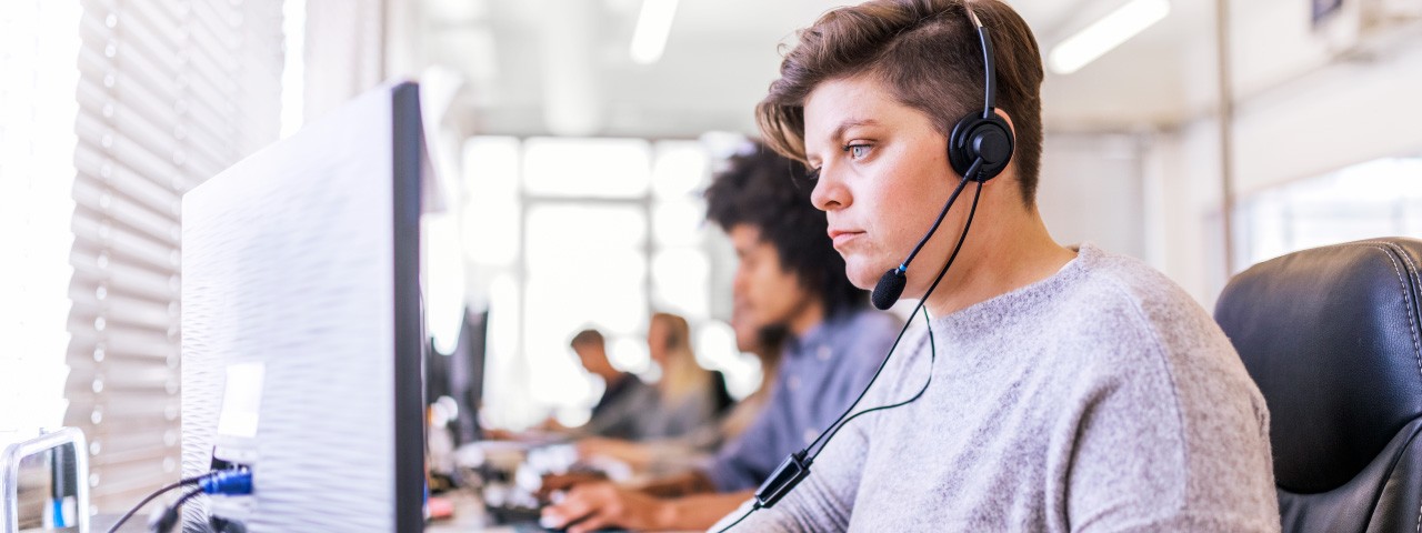 person on phone in call center