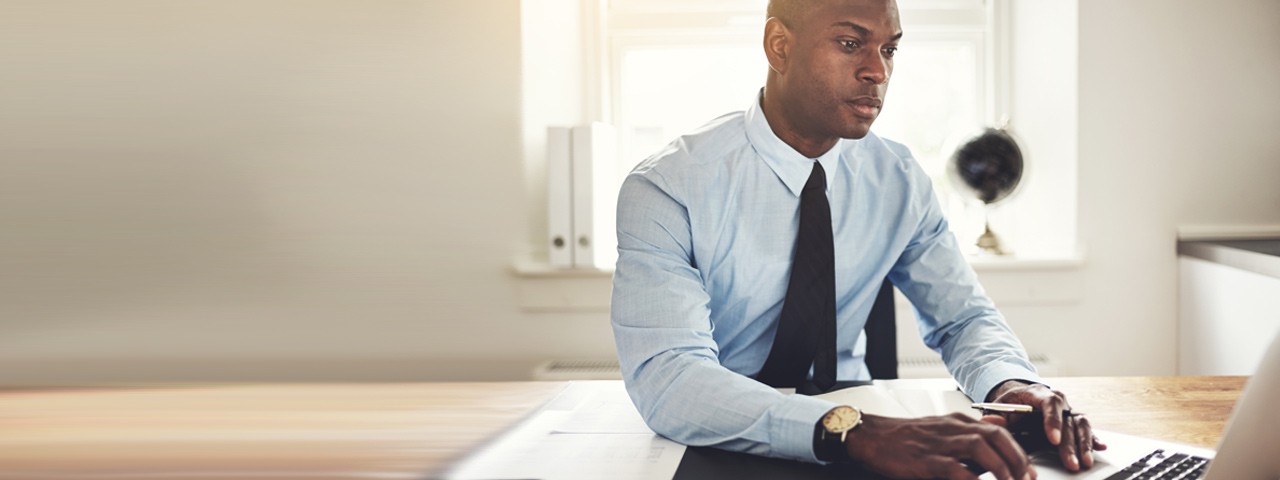 man in suit with laptop