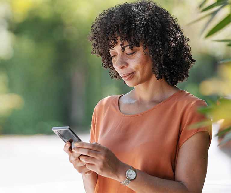 Woman looking down at smartphone