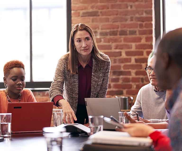 Woman standing up during a work meeting.