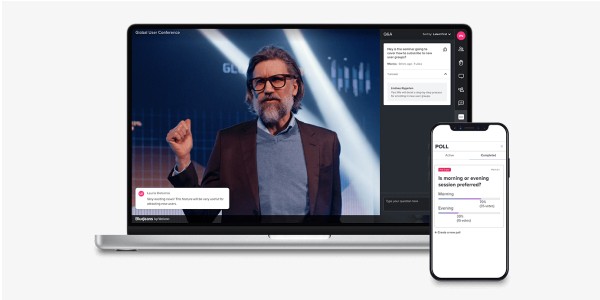 Laptop and phone displaying virtual meeting info
