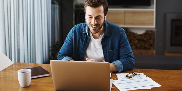 Man sitting at a desk typing on a computer.
