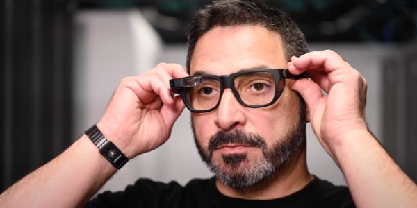 Man adjusting his Google Glass glasses on his face
