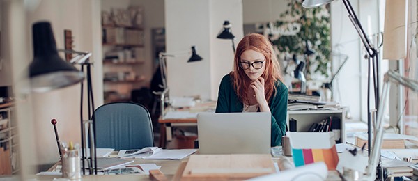 Woman looking down at her laptop.