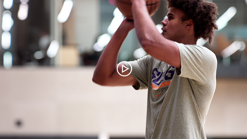 Basketball player trains in gym equipped with high-tech sensors and cameras