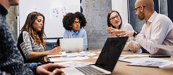 Group of coworkers having a meeting at table.