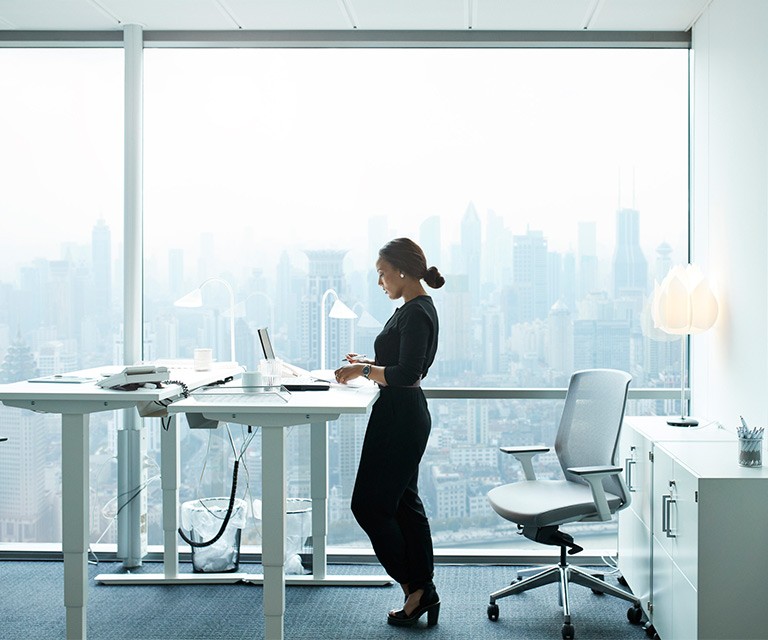Women using laptop at standing desk