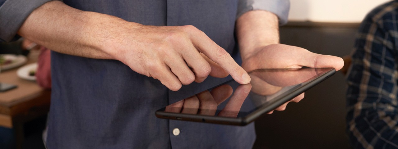 hand touching mobile device screen
