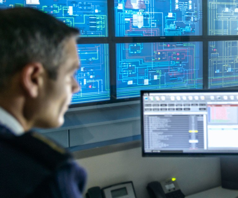 man in front of two monitors