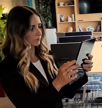 woman looking at tablet in office