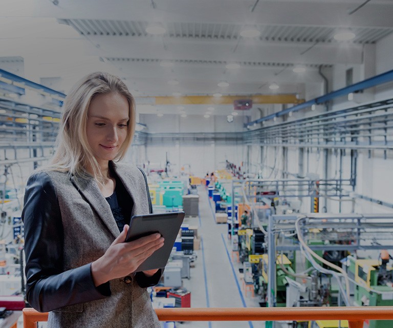 Woman using tablet in factory.