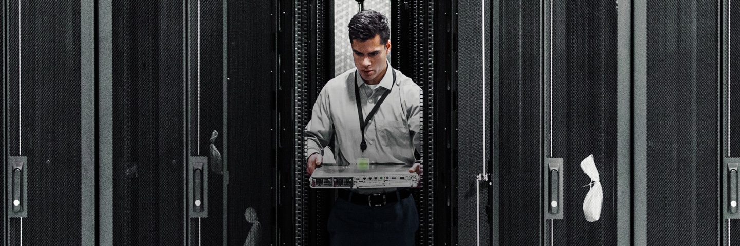 man carries a server in a data center