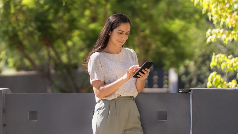 woman outside with smart device