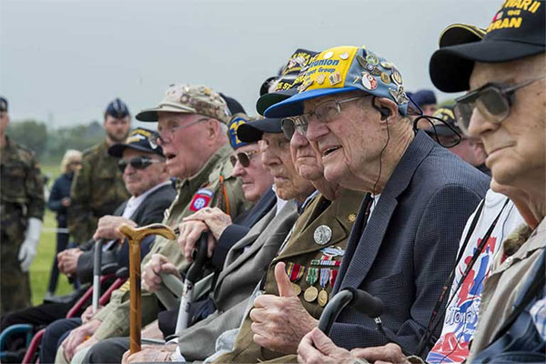 A group of veterans sitting down and being honored.