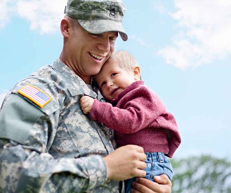 Veteran holding a child