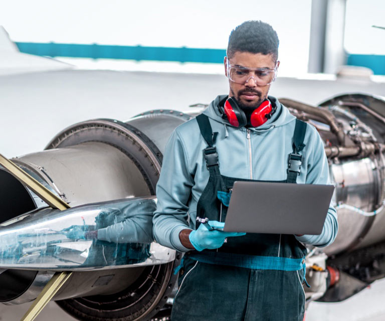employee in front of industrial equipment