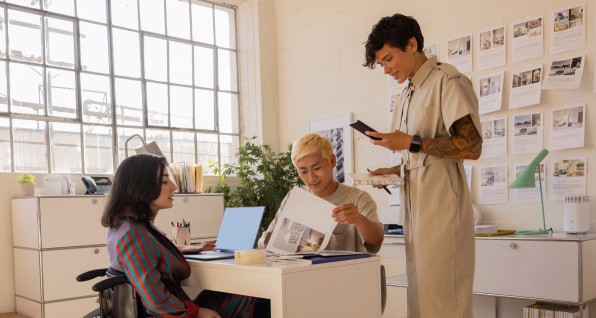 three people collaborating in office