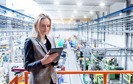 Woman viewing table in factory