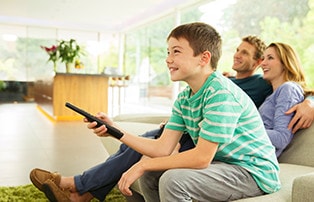 A boy and his father enjoying Fios TV.